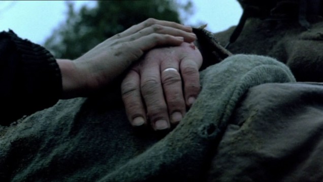 Elizabeth clasps Justin's hand